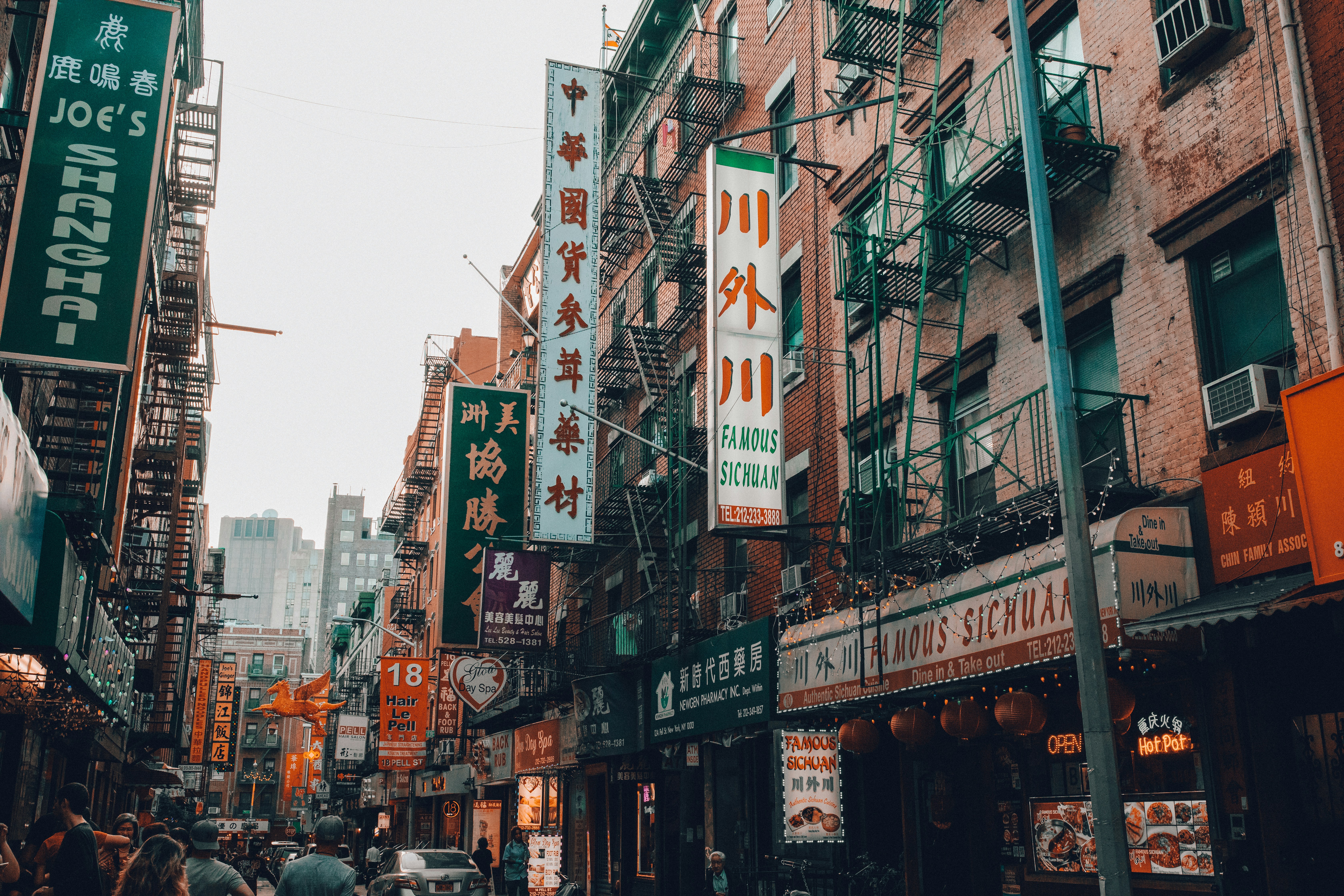 Chinatown in the daytime, in Chinatown, Manhattan. Numerous signs are advertising the various Chinese businesses in the area. Photo by Wes Hicks.